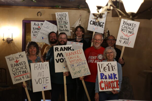 Enthusiastic supporters hold their Rank MI Vote signs